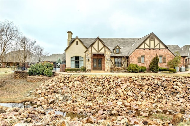 tudor-style house with central air condition unit