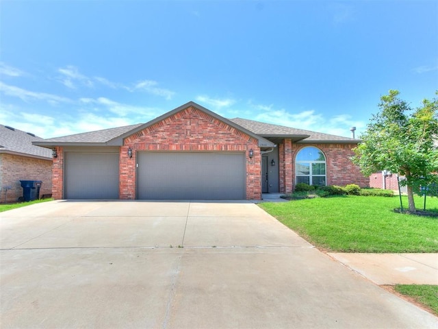 ranch-style home featuring a garage and a front lawn