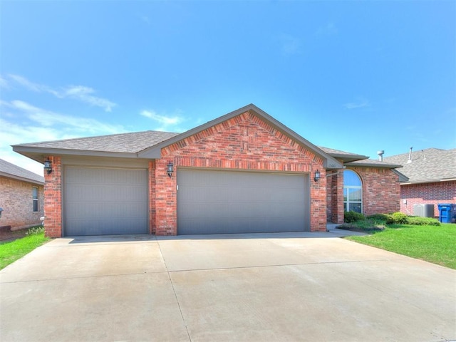 single story home with a garage and central air condition unit