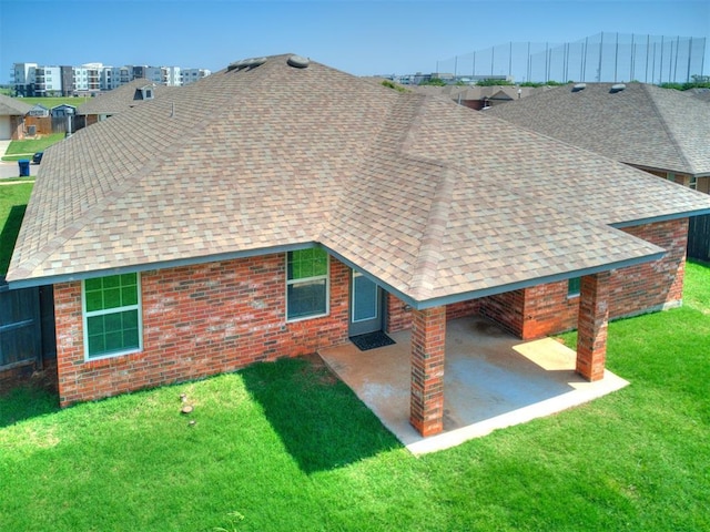 back of house with a yard and a patio area