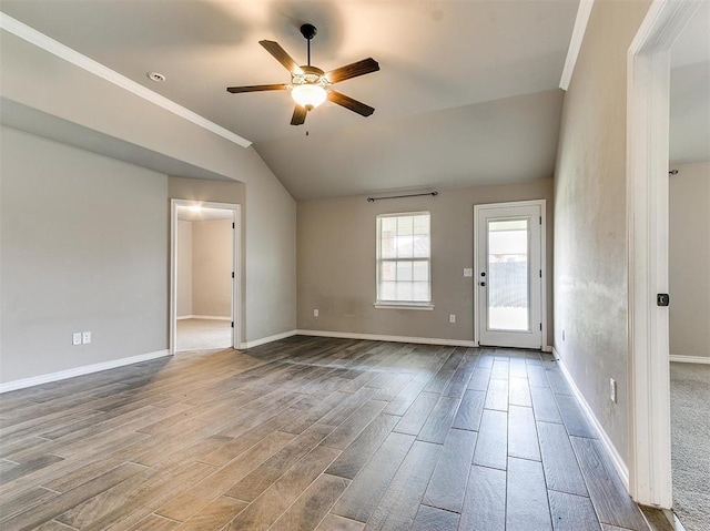 spare room featuring crown molding, ceiling fan, vaulted ceiling, and light hardwood / wood-style flooring