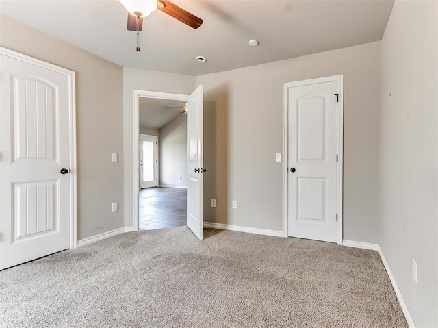 unfurnished bedroom with ceiling fan and carpet flooring