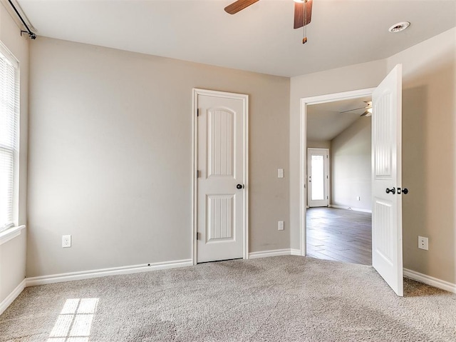 spare room with ceiling fan and carpet flooring