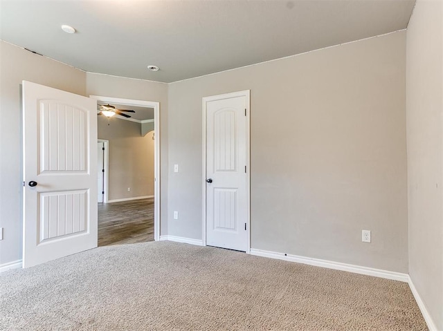 unfurnished room featuring ceiling fan and carpet floors