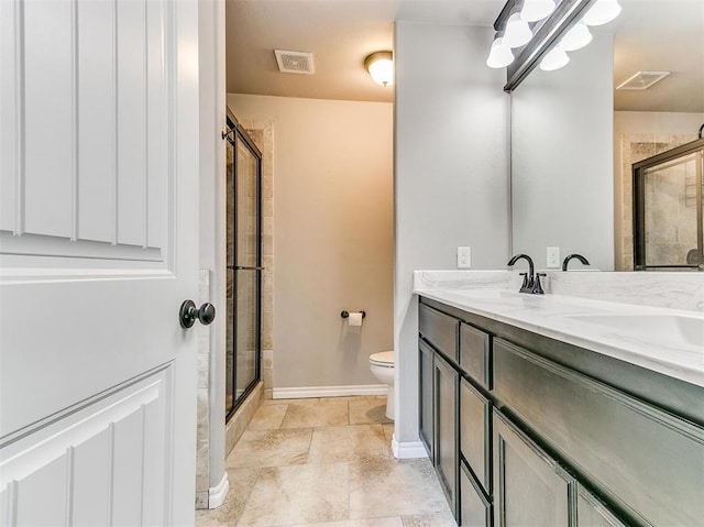 bathroom with walk in shower, vanity, and toilet