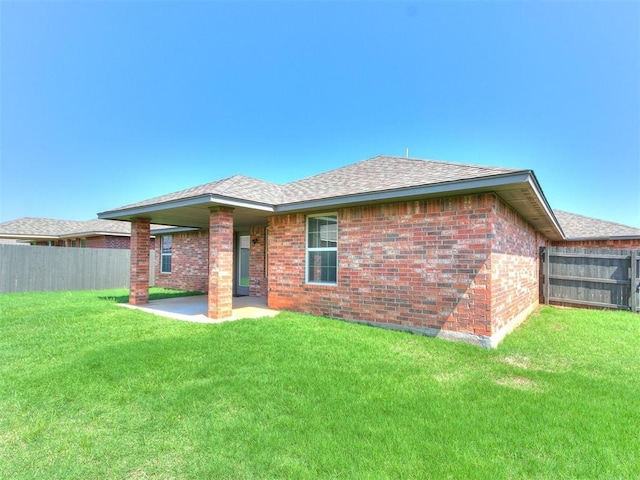 back of property featuring a yard and a patio area