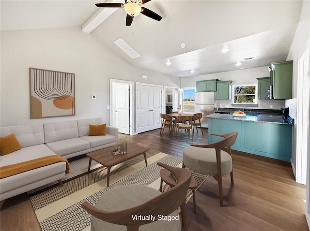 living room featuring vaulted ceiling with beams, dark wood-type flooring, and ceiling fan