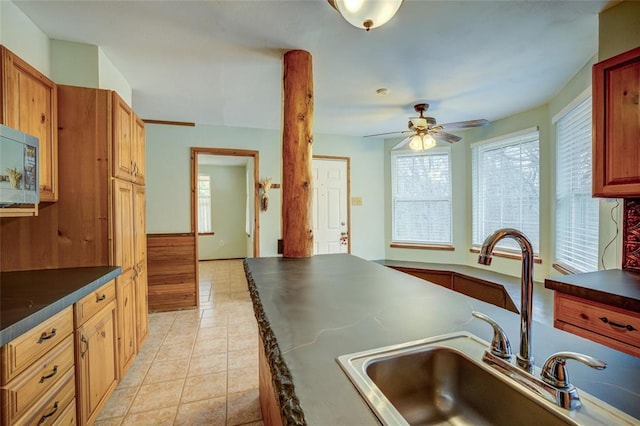 kitchen featuring sink, light tile patterned floors, and ceiling fan