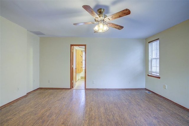 empty room featuring dark hardwood / wood-style floors and ceiling fan