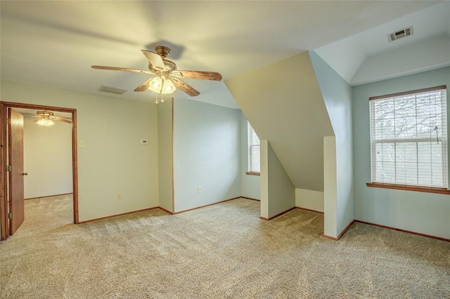 bonus room featuring lofted ceiling, light colored carpet, and ceiling fan