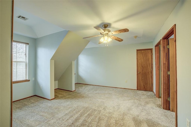 bonus room with ceiling fan, vaulted ceiling, and light carpet