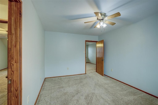 carpeted empty room featuring ceiling fan