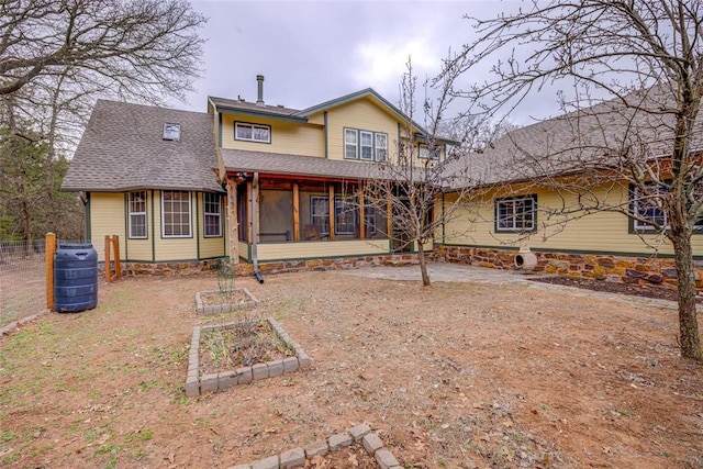 rear view of property with a sunroom