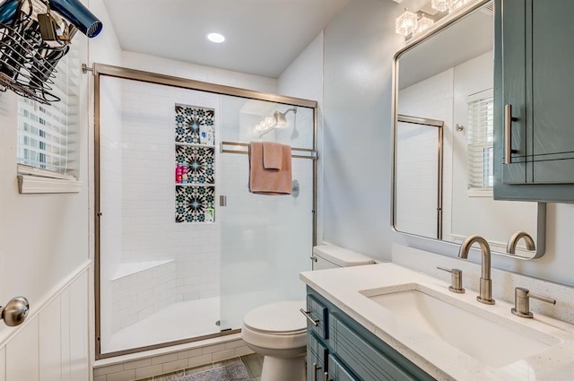 bathroom with vanity, an enclosed shower, and toilet