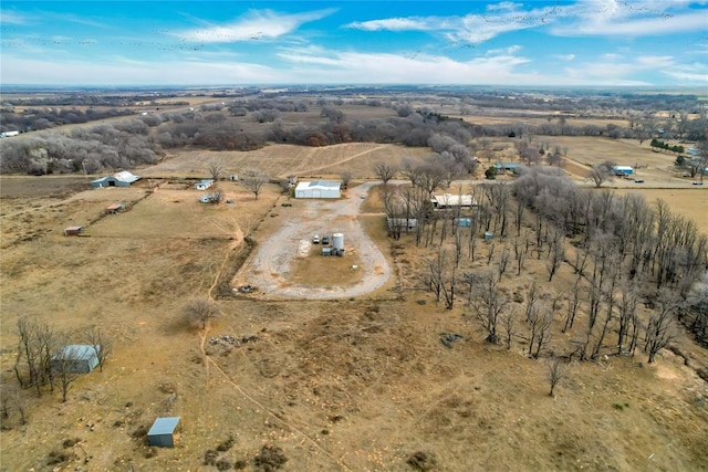 birds eye view of property with a rural view