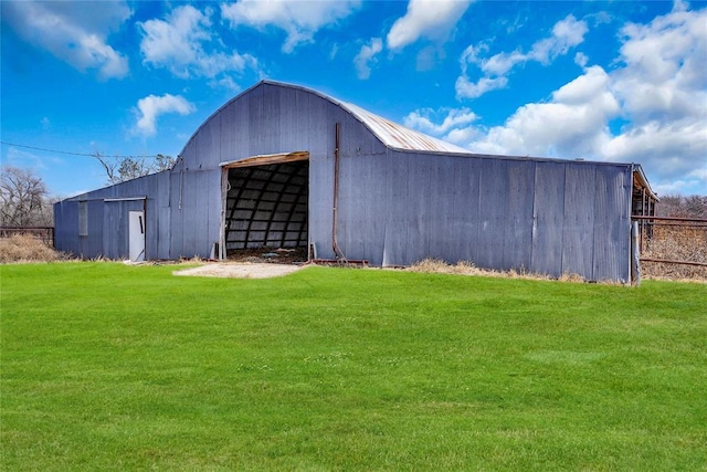 view of outbuilding with a yard