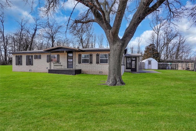 view of front of home with a front lawn and a storage unit