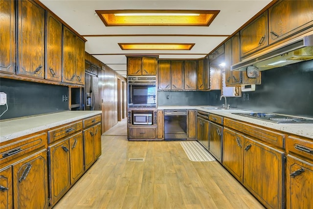 kitchen featuring sink, black appliances, and light hardwood / wood-style floors