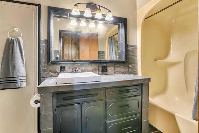 bathroom featuring vanity, backsplash, and a shower with shower curtain