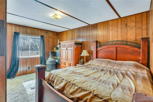 carpeted bedroom featuring wood walls