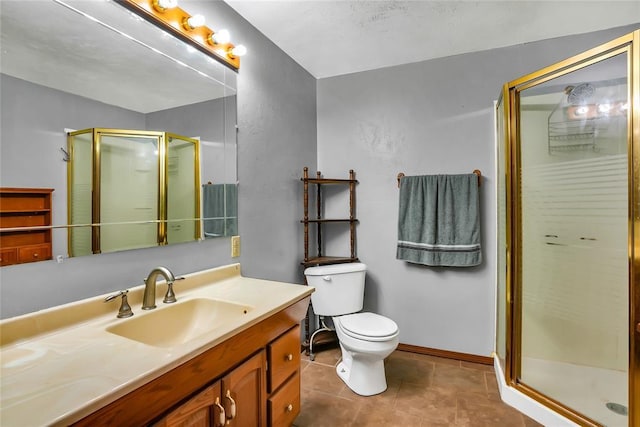 bathroom featuring tile patterned flooring, vanity, toilet, and walk in shower