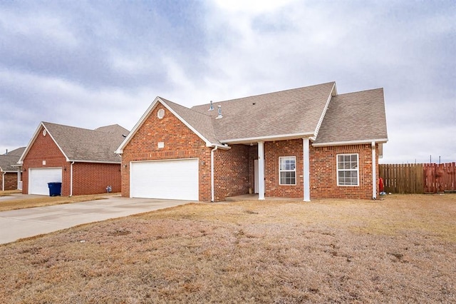 ranch-style house featuring a garage and a front yard