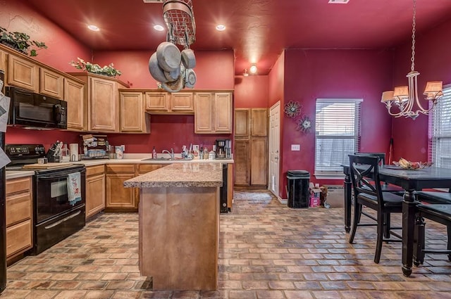 kitchen with sink, an inviting chandelier, a kitchen island, pendant lighting, and black appliances