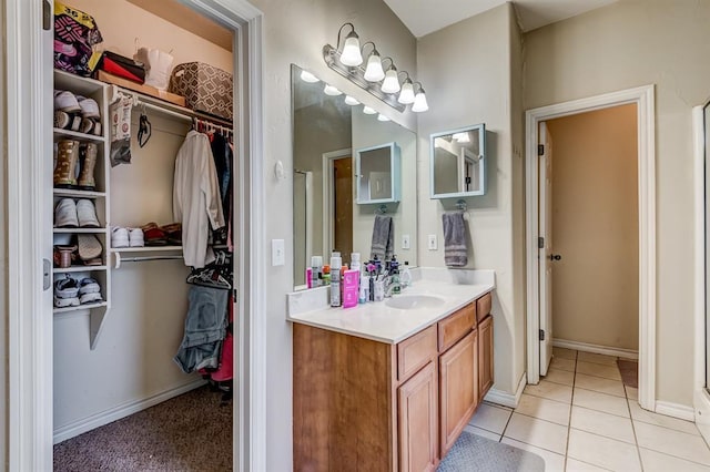 bathroom with vanity, a shower with door, and tile patterned floors