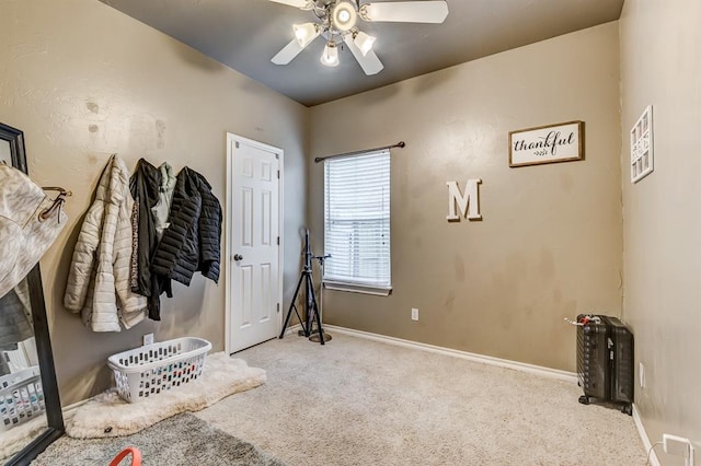 interior space featuring light colored carpet and ceiling fan