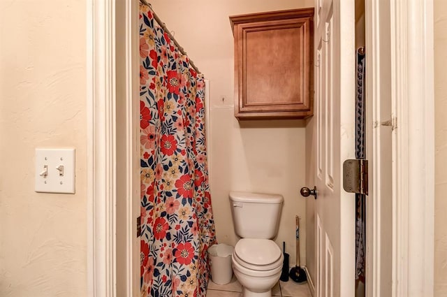 bathroom with tile patterned flooring and toilet