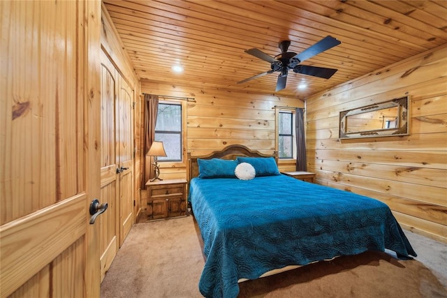 bedroom featuring wood ceiling, light colored carpet, and multiple windows