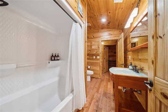 full bathroom with hardwood / wood-style flooring, vanity, wood ceiling, toilet, and shower / bath combo