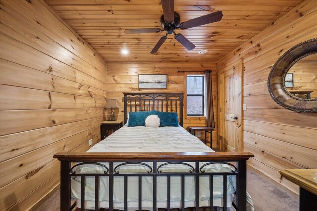 unfurnished bedroom with wood ceiling, wooden walls, and dark colored carpet