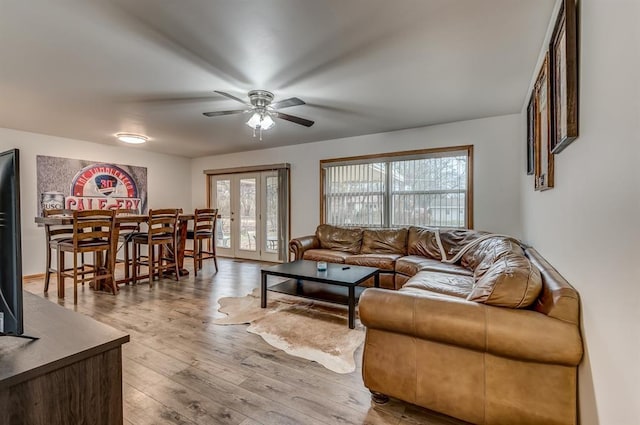 living room with french doors, ceiling fan, and light hardwood / wood-style floors