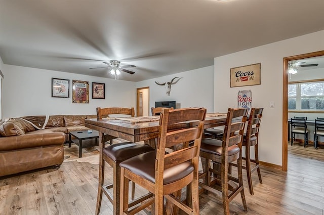 dining area with ceiling fan and light wood-type flooring