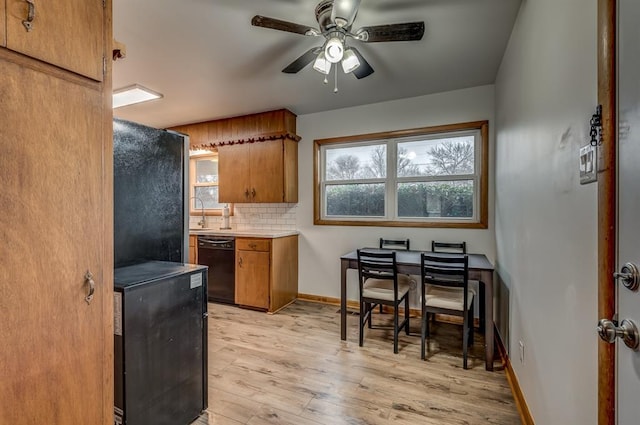 kitchen featuring ceiling fan, dishwasher, refrigerator, backsplash, and light hardwood / wood-style floors