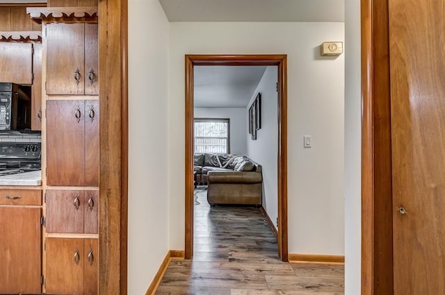 hall with light hardwood / wood-style floors