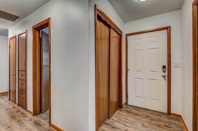 hallway with light hardwood / wood-style floors