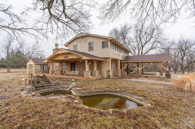 back of property with a gazebo