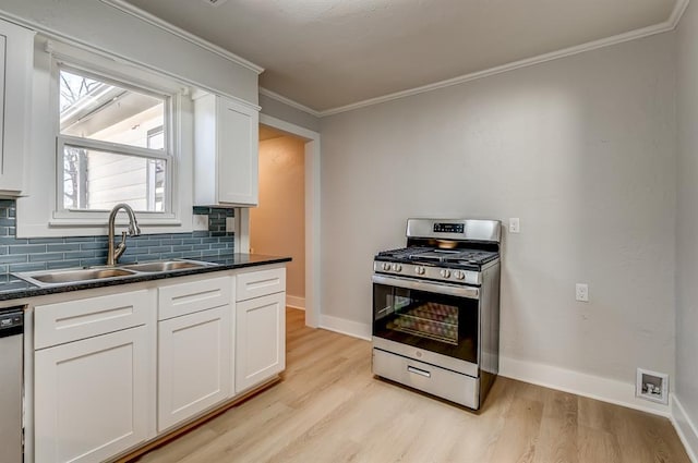 kitchen with sink, crown molding, white cabinetry, backsplash, and stainless steel appliances