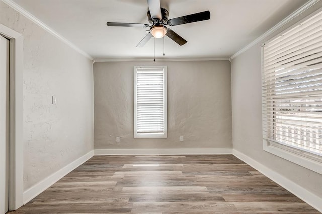 spare room with ornamental molding, ceiling fan, and light wood-type flooring