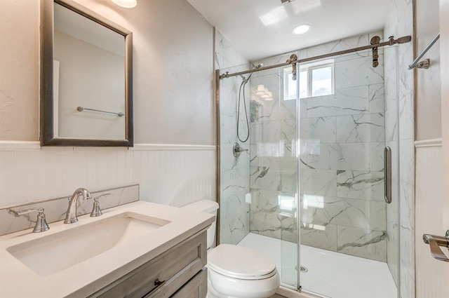 bathroom featuring an enclosed shower, vanity, and toilet