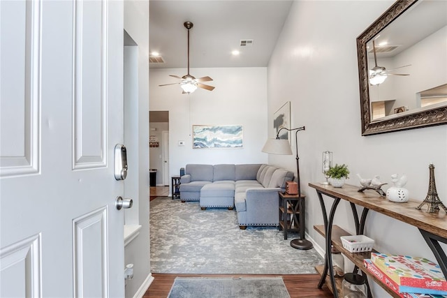 living room featuring hardwood / wood-style flooring and ceiling fan