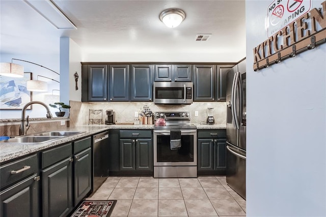 kitchen featuring sink, stainless steel appliances, tasteful backsplash, light stone countertops, and light tile patterned flooring