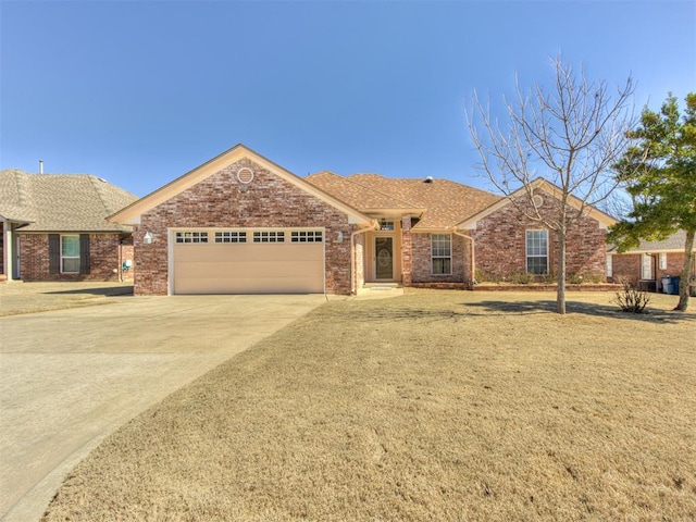 ranch-style home featuring driveway, a garage, and brick siding