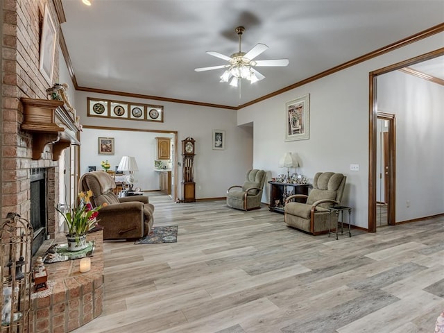 living area featuring light wood-style floors, ceiling fan, a fireplace, and baseboards