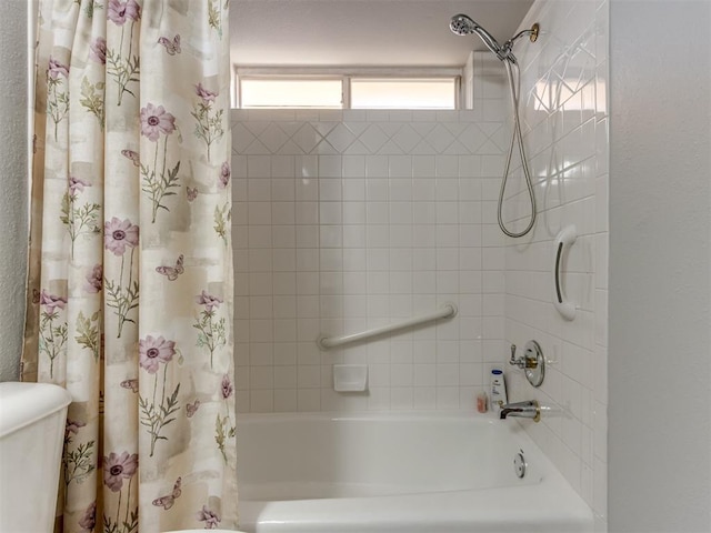 bathroom featuring shower / tub combo with curtain and toilet