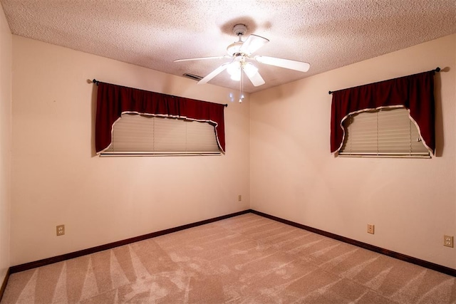 spare room with ceiling fan, carpet floors, and a textured ceiling