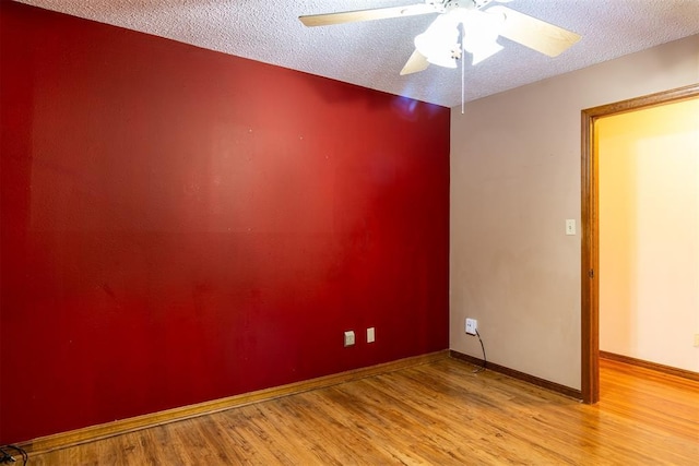 unfurnished room with ceiling fan, a textured ceiling, and light hardwood / wood-style floors