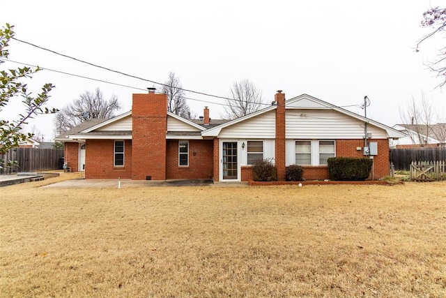 rear view of property with a lawn